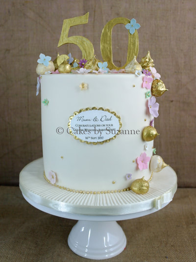 double height 50th wedding anniversary cake gold meringues blossoms