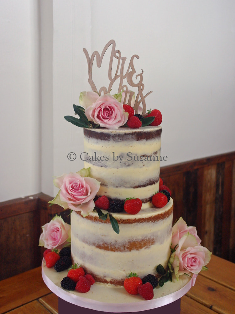 last minute two tier round semi naked wedding cake with fresh fruit and flowers