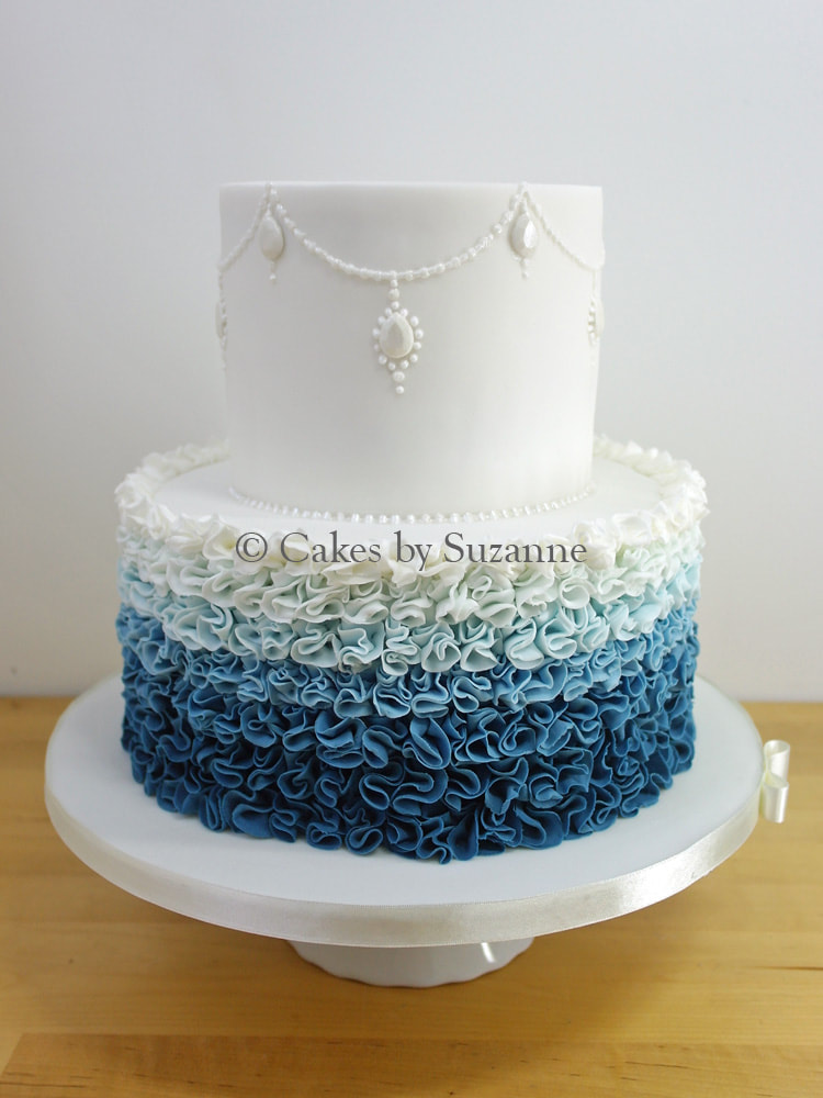 two tier round wedding cake with ombre blue ruffles