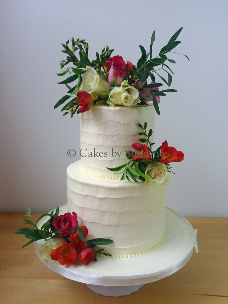last minute two tier round textured buttercream wedding cake with fresh flowers.