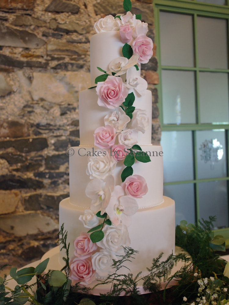 four tier dual theme wedding cake flower cascade Superhero