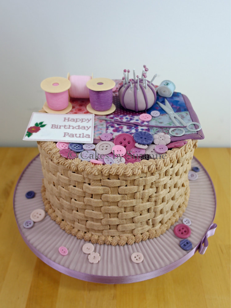 sewing basket cake with edible spools, pincushion, scissors, buttons and tape measure
