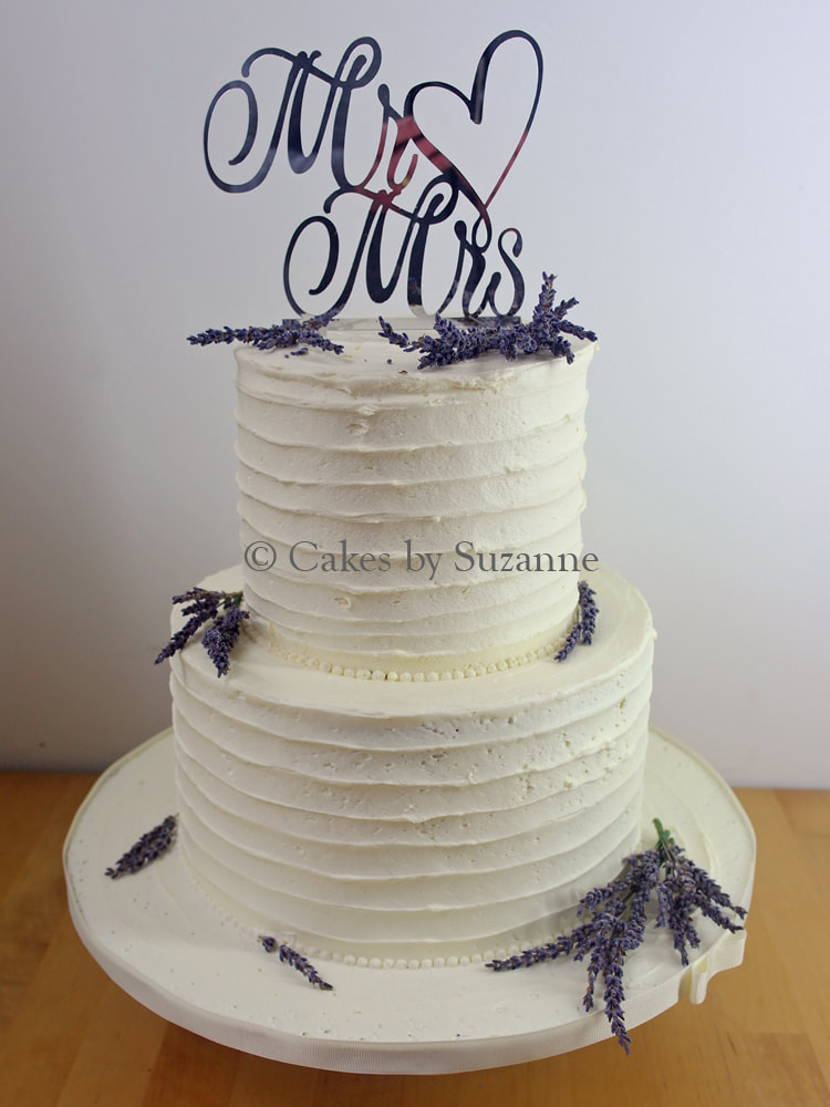 two tier round buttercream wedding cake with dried lavender and heart Mr and Mrs topper