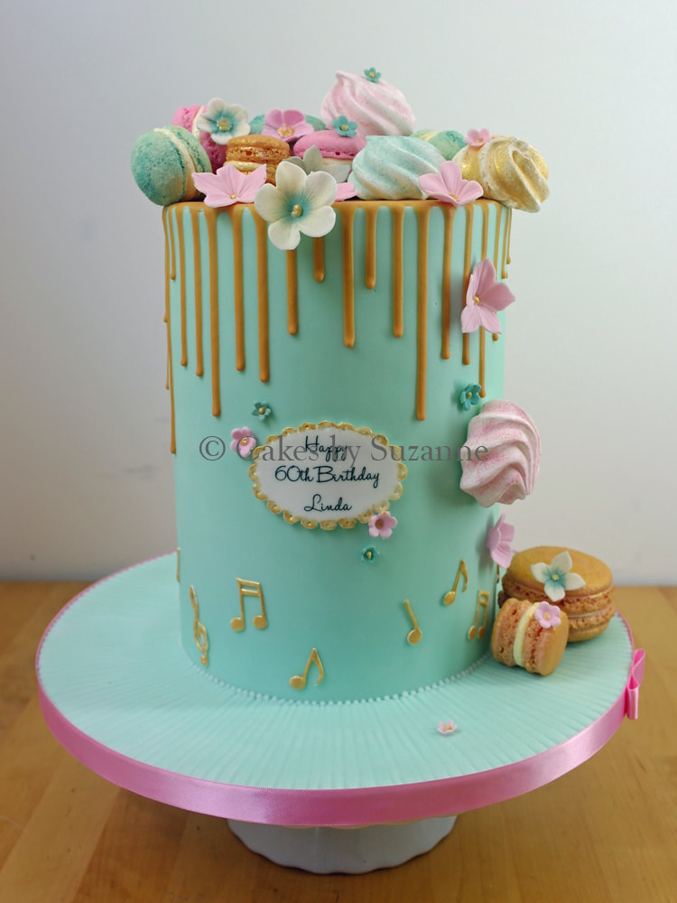 double height tall drip effect cake with macarons, sugar blossoms and musical notes