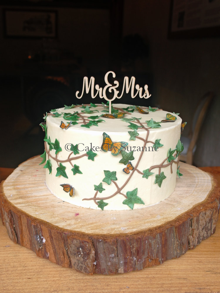 single tier rustic buttercream wedding cake with sugar ivy and butterflies