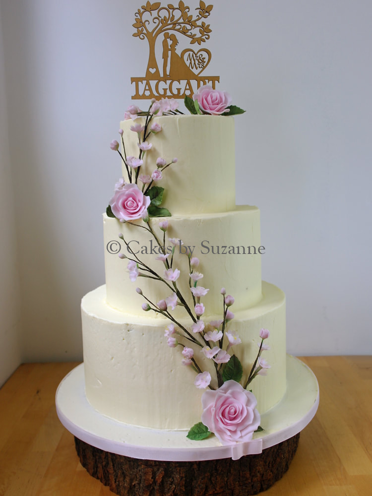 three tier round stacked buttercream wedding cake with sugar roses and cherry blossom