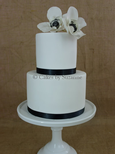 two tier black white round wedding cake anemones