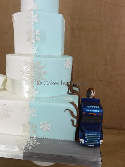 four tier dual theme wedding cake front snowflake winter wonderland back lorry bride groom