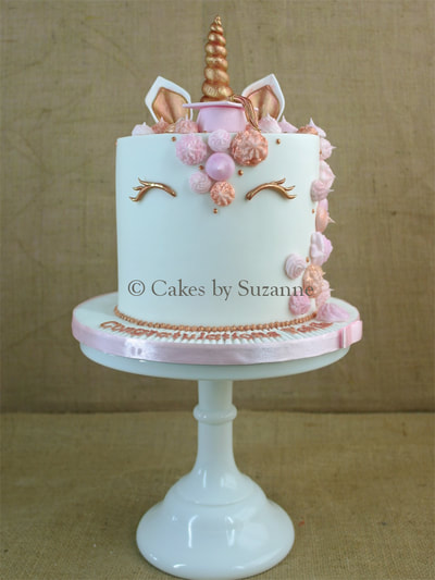 round unicorn rose gold birthday cake