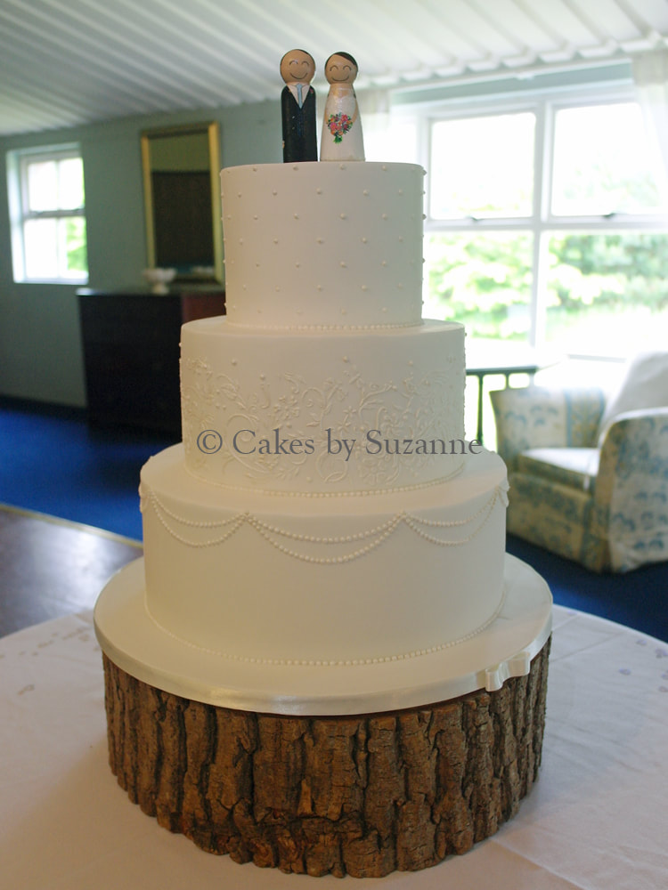 three tier round wedding cake with stencilled lace, piping