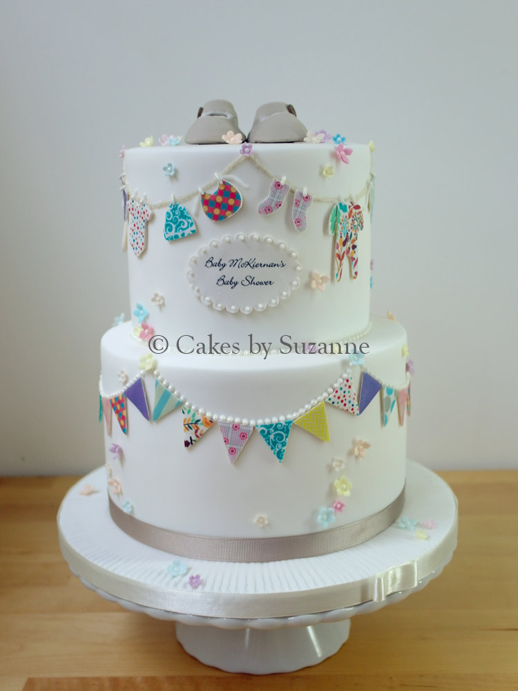 Baby shower cake two tier round baby shoes clothing bunting