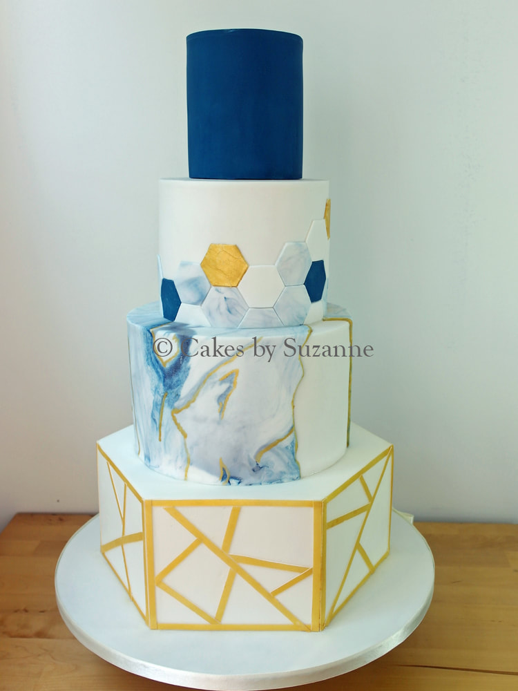 four tier round hexagon wedding cake blue gold marbled