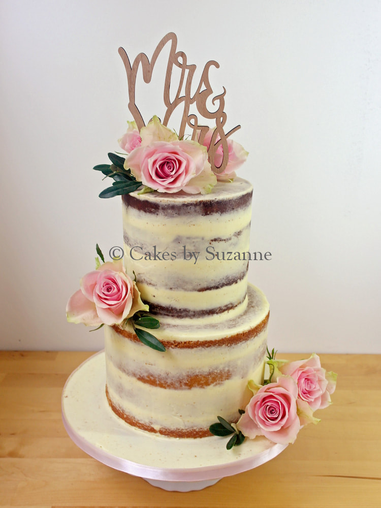 last minute two tier round semi naked buttercream wedding cake with fresh flowers