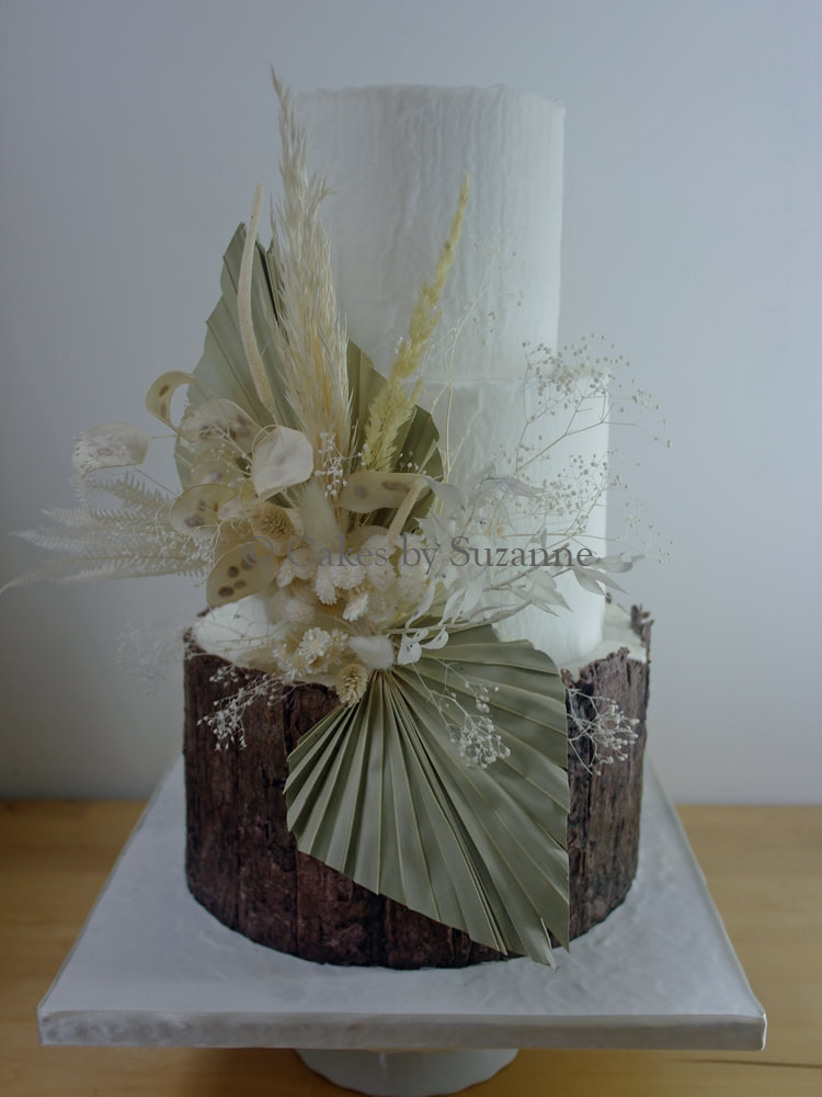 three tier rustic round buttercream wedding cake with bark tree effect, palm spears, dried flowers