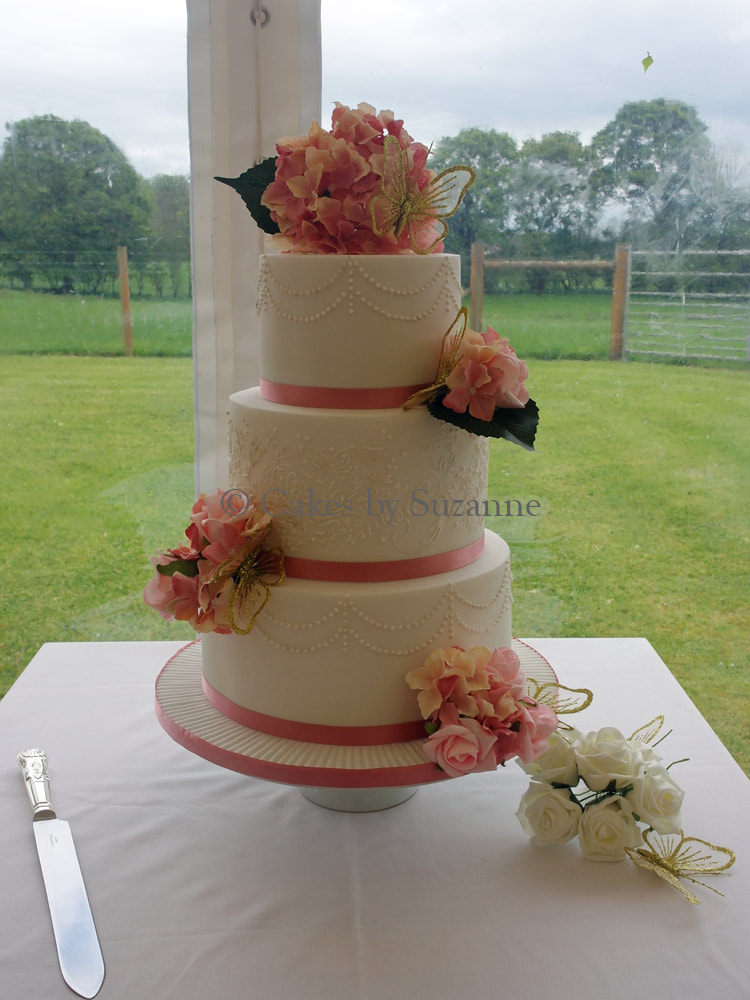 three tier round wedding cake with hydrangea