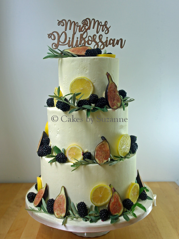 last minute three tier round buttercream wedding cake with lemons, figs, blackberries and olive leaves