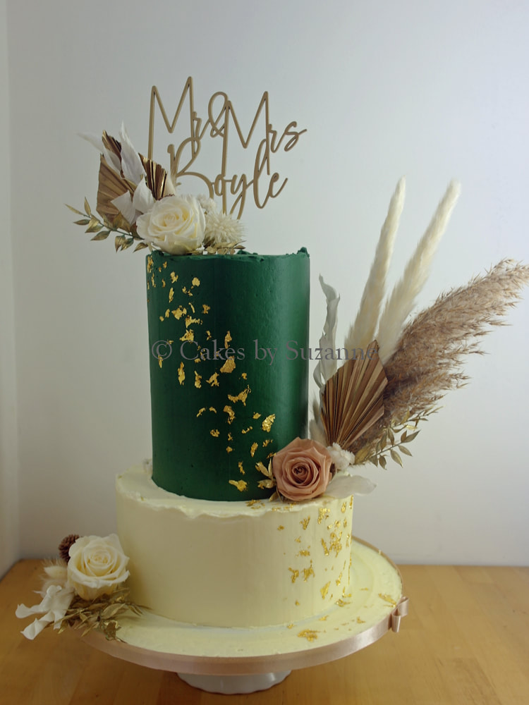 three tier round stacked buttercream wedding cake with dried flowers and personalised topper