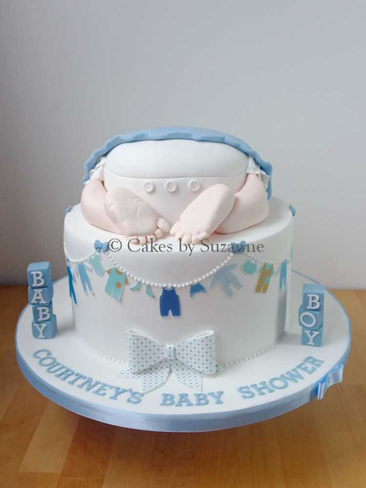 boy's baby shower cake with baby bottom top tier