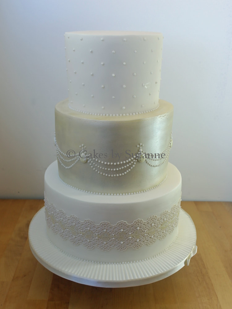 three tier round stacked wedding cake with lustre, sugar pearls and lace