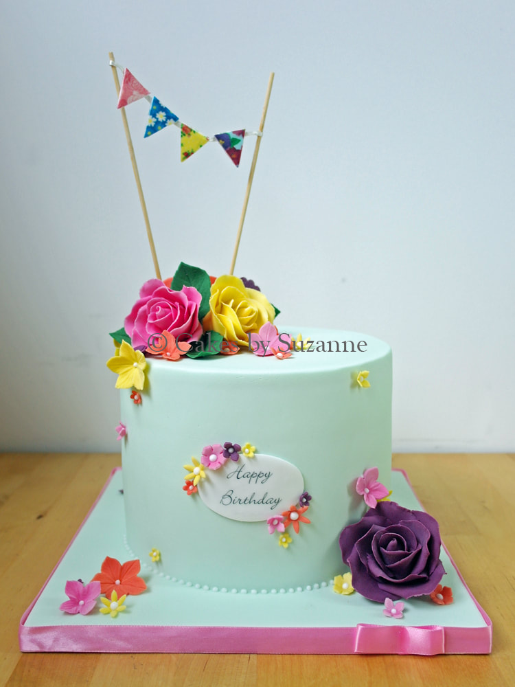 floral birthday cake with bright sugar roses and blossoms