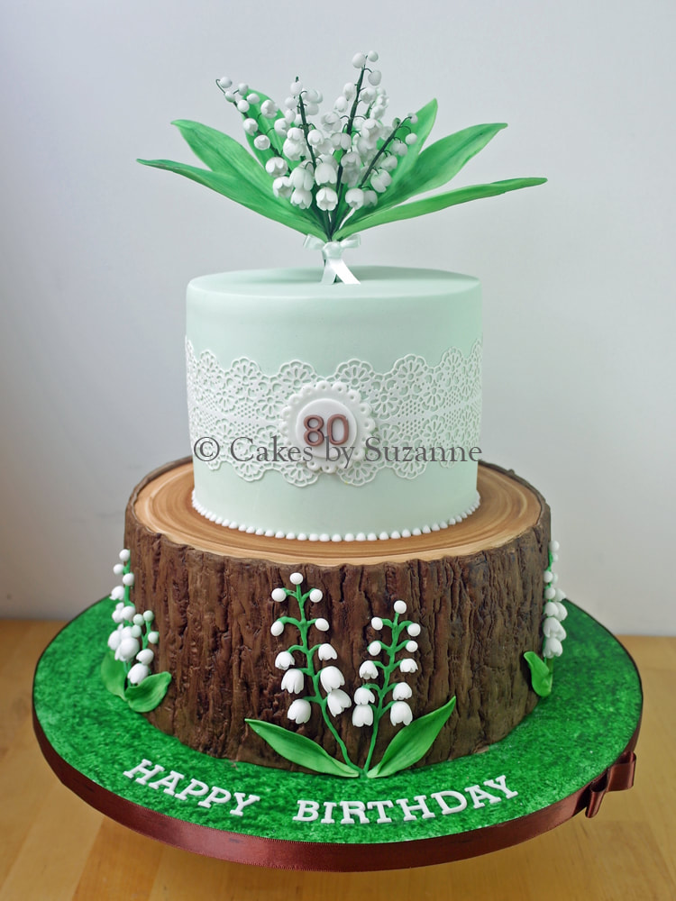 two tier 80th birthday cake with sugar lily of the valley