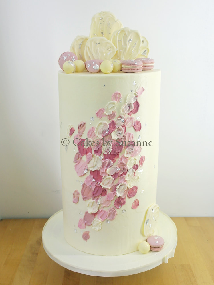 triple height buttercream wedding cake with macarons, truffles and white chocolate shards