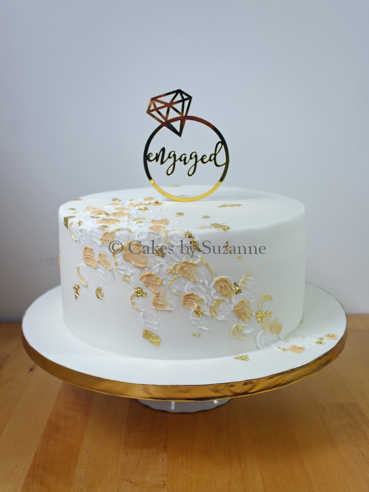 engagement cake with gold texture and leaf detail and engaged topper