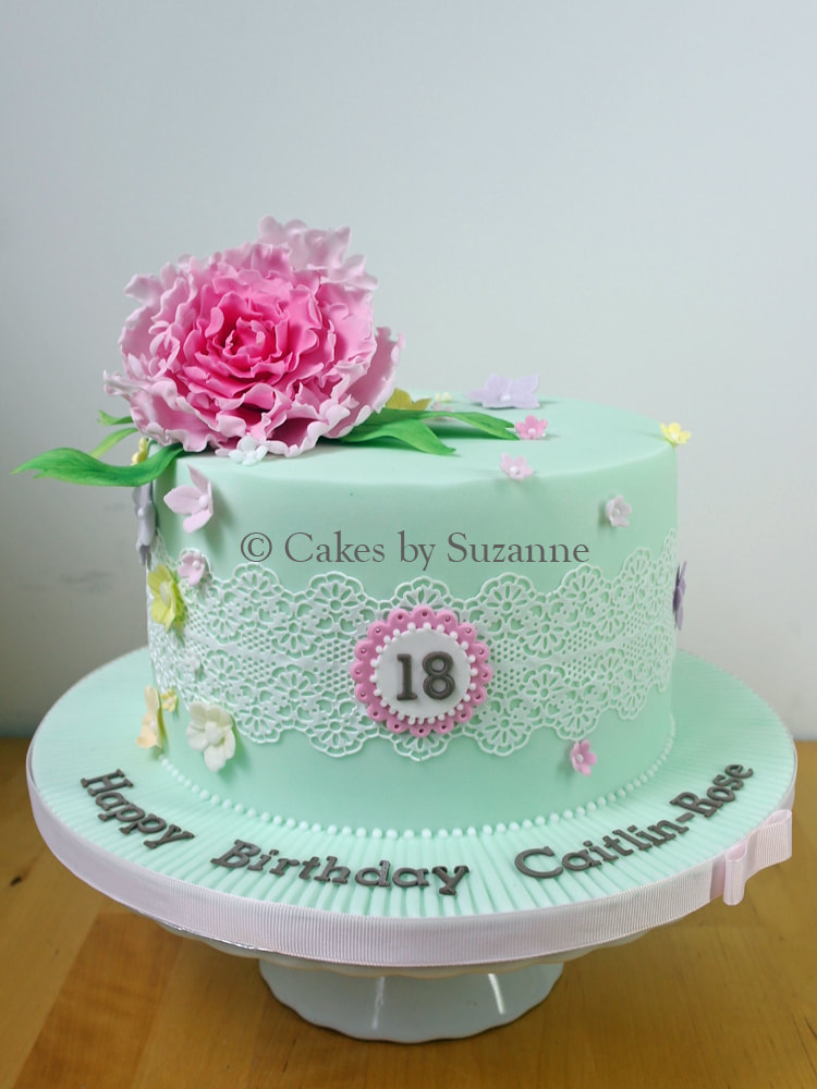 pretty 18th birthday cake in mint green with pink peony, blossoms and lace