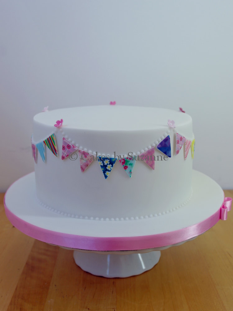 simple cake for any occasion decorated with bunting around the sides