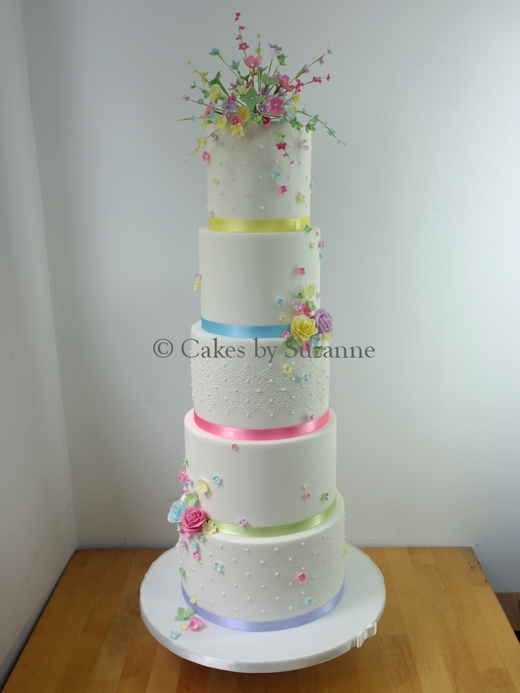 five tier round stacked dual theme wedding cake front with floral design