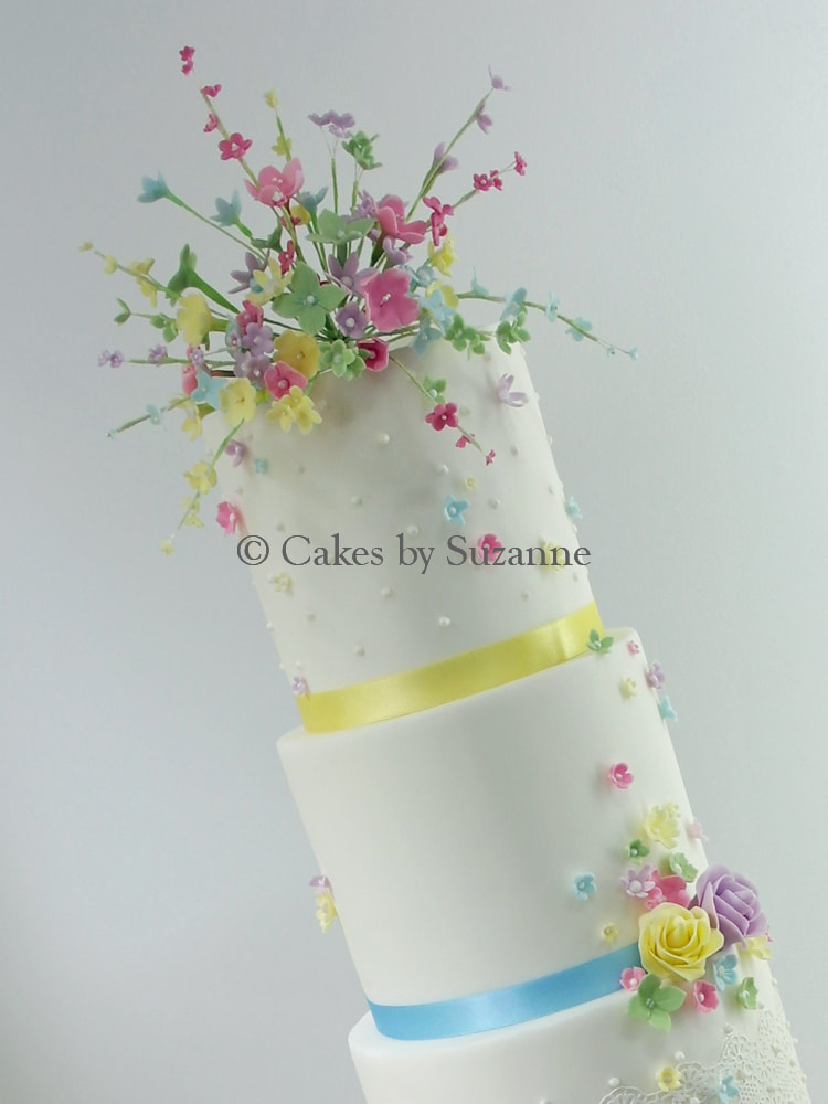 detail of sugar flowers at front of dual theme wedding cake