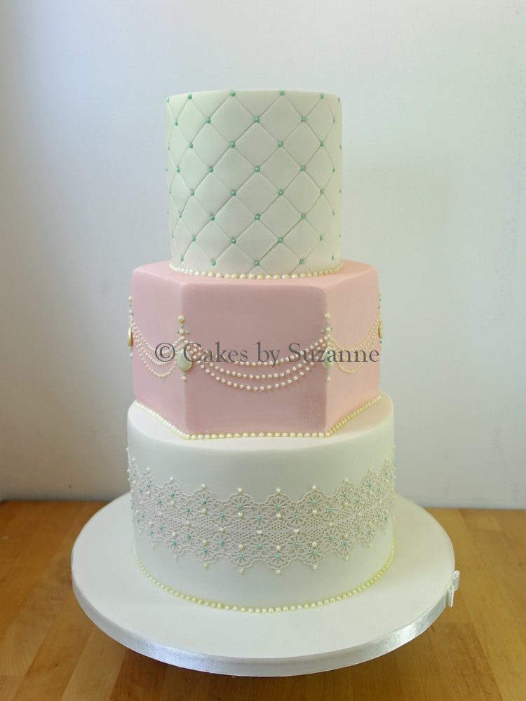 three tier round and hexagon wedding cake with quilting, sugar pearls and lace