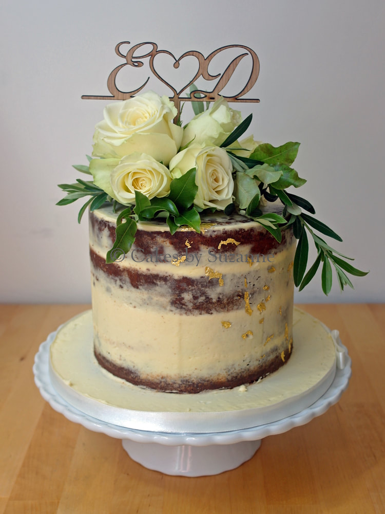 single tier semi naked buttercream wedding cake with fresh flowers