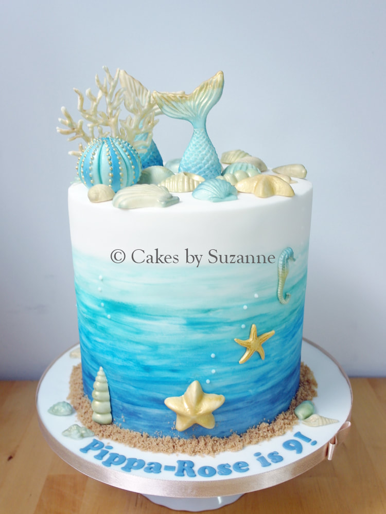Seaside seashell themed birthday cake with shells, coral, sea urchin, mermaids tail