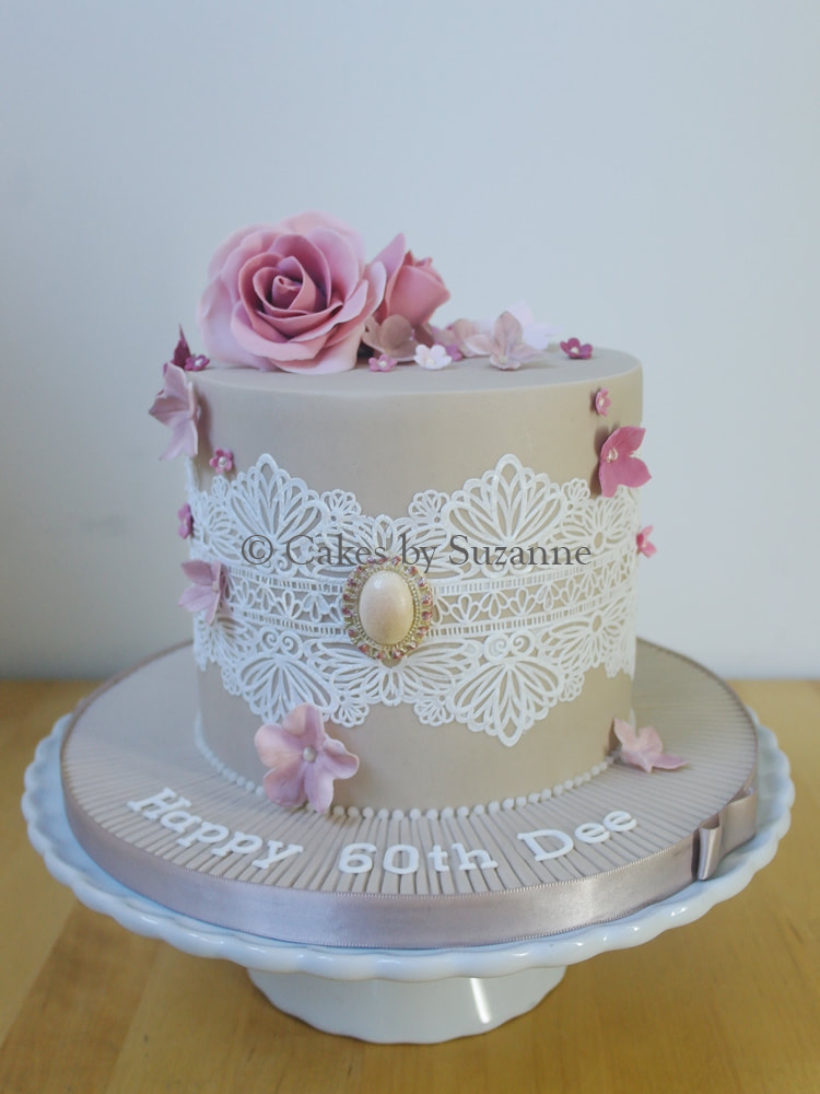 vintage 60th birthday cake with lace, brooch, dusky roses and blossoms