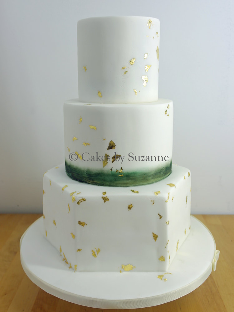 three tier round and hexagon wedding cake with colour wash middle tier and gold leaf detail