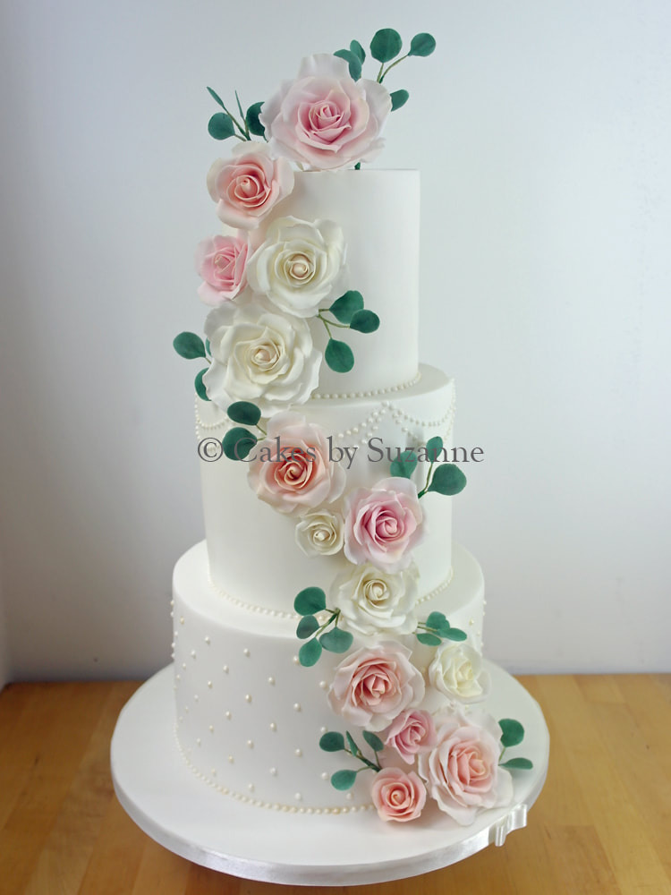 3 tier round stacked cake with cascade of ivory and blush sugar roses and eucalyptus
