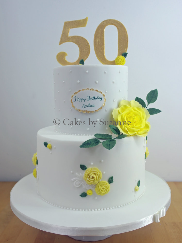 two tier round 50th birthday cake with yellow roses