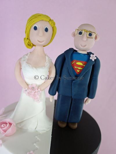 three tier round split theme wedding cake pink flowers bride groom Batman Superman Captain America